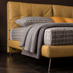 Glacia is a mustard yellow upholstered bed made for homes that prefer a soft yet structured bedroom centrepiece