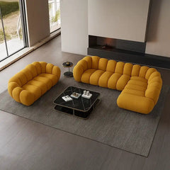 soft curved sofa with rounded cushion sections, a cloud like shape and a low relaxed base — alternate angle showing the fu...