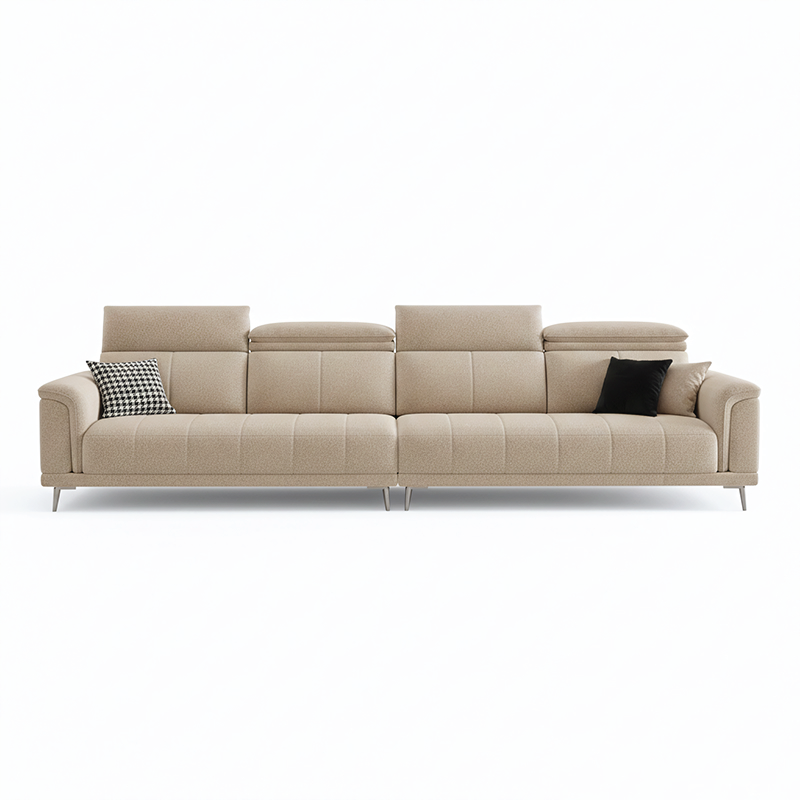 beige l shape sofa with adjustable head support, rounded arms and slim raised legs — close view showing the colour and mat...