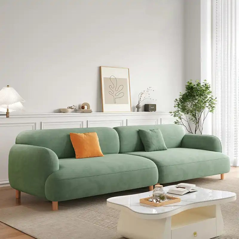 rounded fabric sofa with deep cushions, soft wide arms and a clean modern finish — alternate angle showing the full depth...