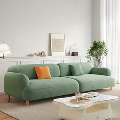 rounded fabric sofa with deep cushions, soft wide arms and a clean modern finish — alternate angle showing the full depth...