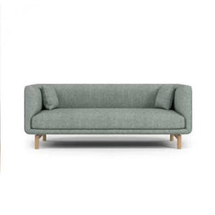 curved fabric sofa with soft wraparound arms, deep cushioning and raised wooden legs — alternate angle showing the full de...