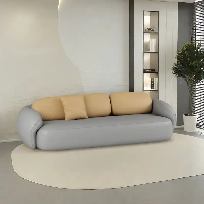 soft curved fabric sofa with cloud like cushions, wraparound arms and a low grounded base — full view with the complete sh...