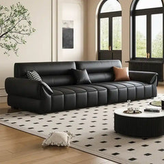 wide leatherette sofa with deep square cushioning and a low relaxed shape — full view with the complete shape clearly visible