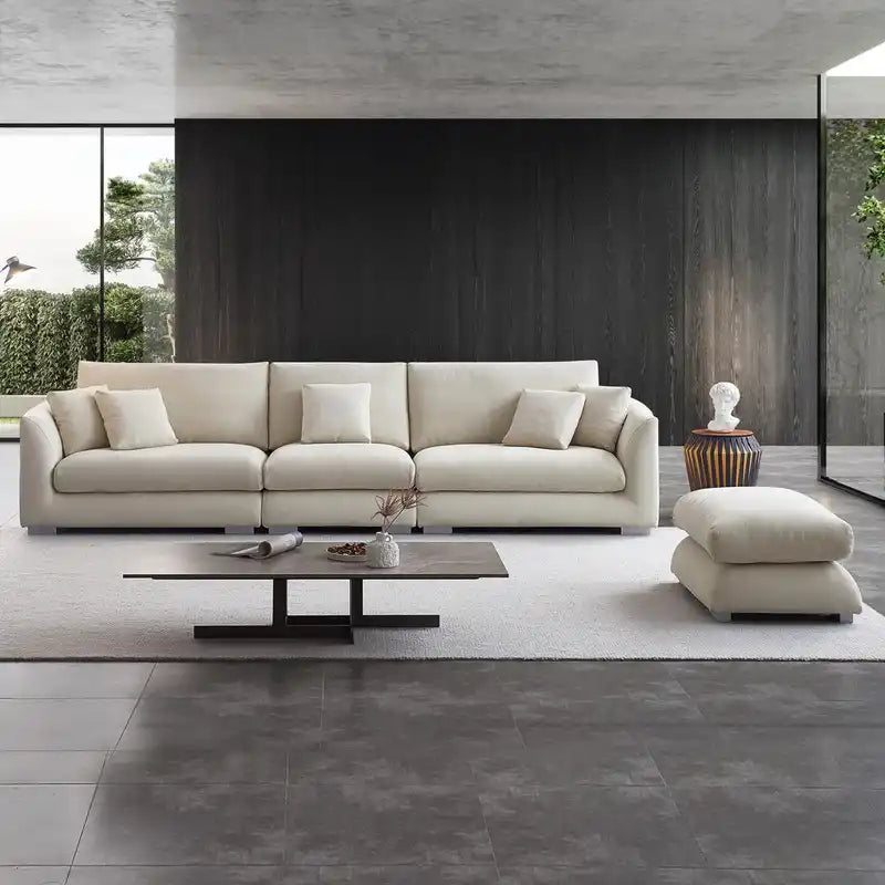 wide l shape fabric sofa with rounded arms, loose back cushions and deep comfortable seating — alternate angle showing the...