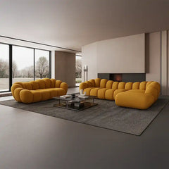 soft curved sofa with rounded cushion sections, a cloud like shape and a low relaxed base — close view showing the colour...