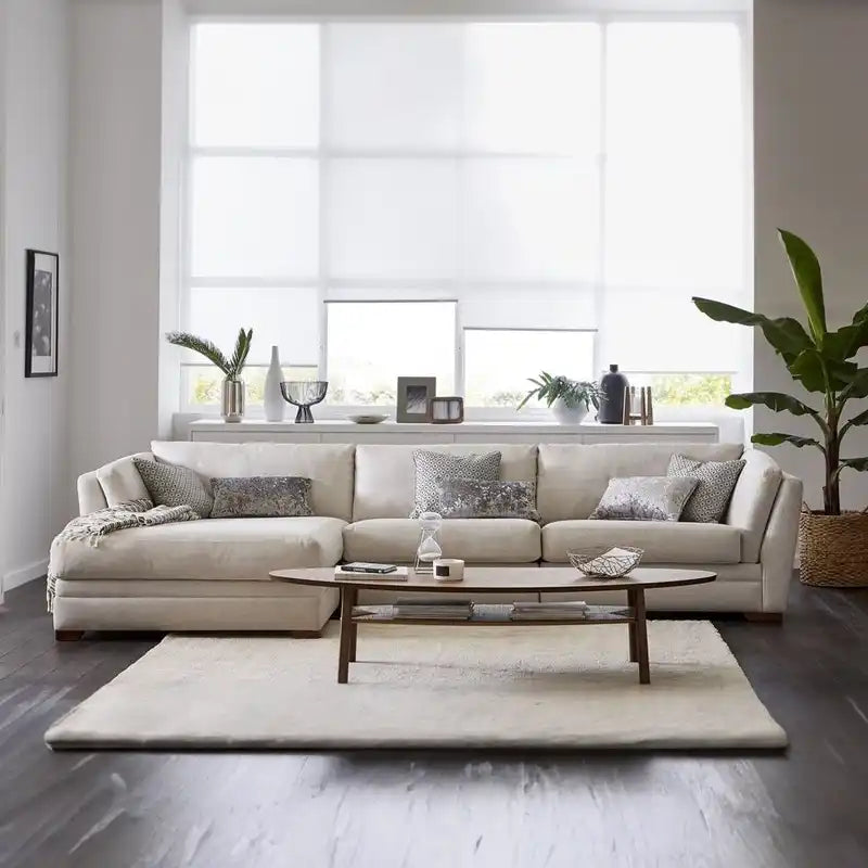 beige corner sofa with a compact l shape, soft cushions and a smooth fabric finish — close view showing the colour and mat...