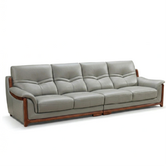 corner sofa with deep cushions, rounded arms and warm polished wooden side details — close view showing the colour and mat...